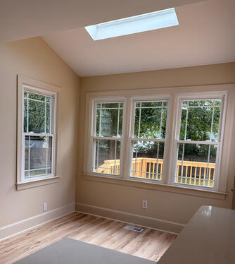 Dinette off of kitchen for informal dining with skylight adding more natural light