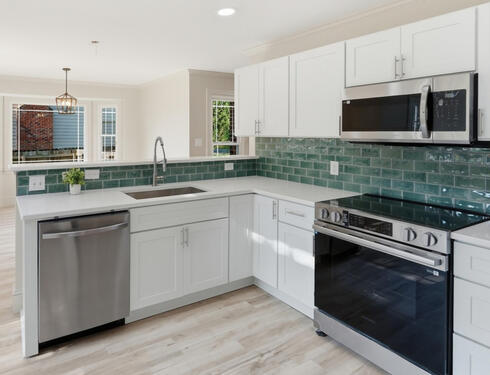 Kitchen with quartz counters and new cabinets. Furnished with Toaster, K-cup coffee maker, Instapot, Air Fryer, Crockpot, Pots and Pans, Utensils, Flatware, Cutting Board, Plates, Bowls and Cups, Coffee Mugs, Baking Pan, Tupperware Set, Mixing bowl, Knife