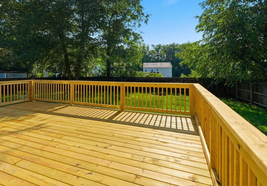 Large Deck overlooking spacious fully fenced back yard with large shade tree. Secure backyard has a nice mix of sunshine and shade for pets and kids alike to